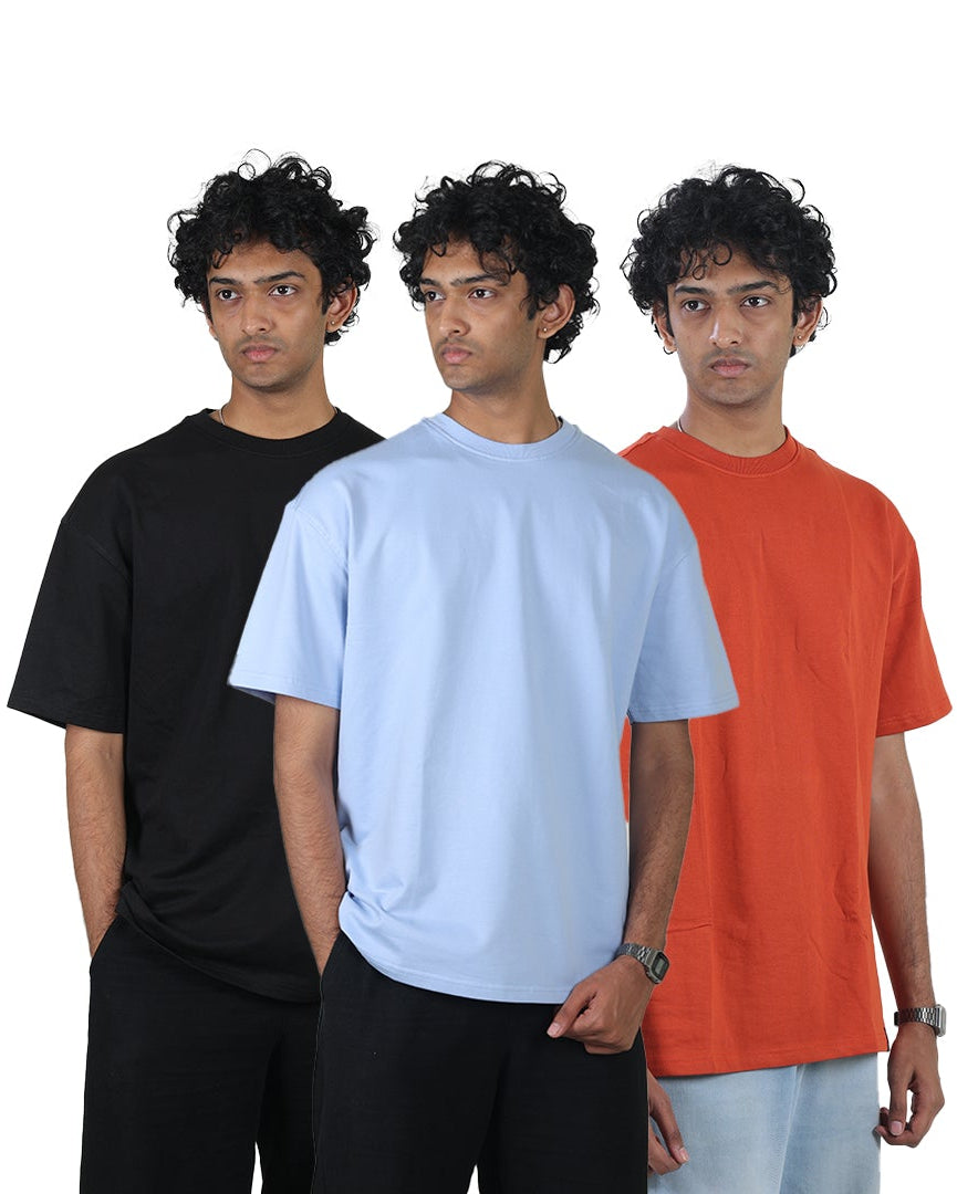 Three individuals wearing black, white, and orange t-shirts on a white background
