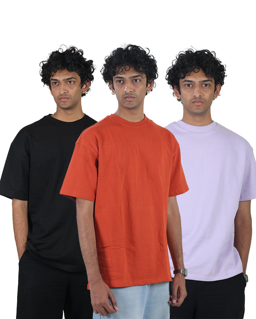 Three people wearing black, orange, and white t-shirts on a white background