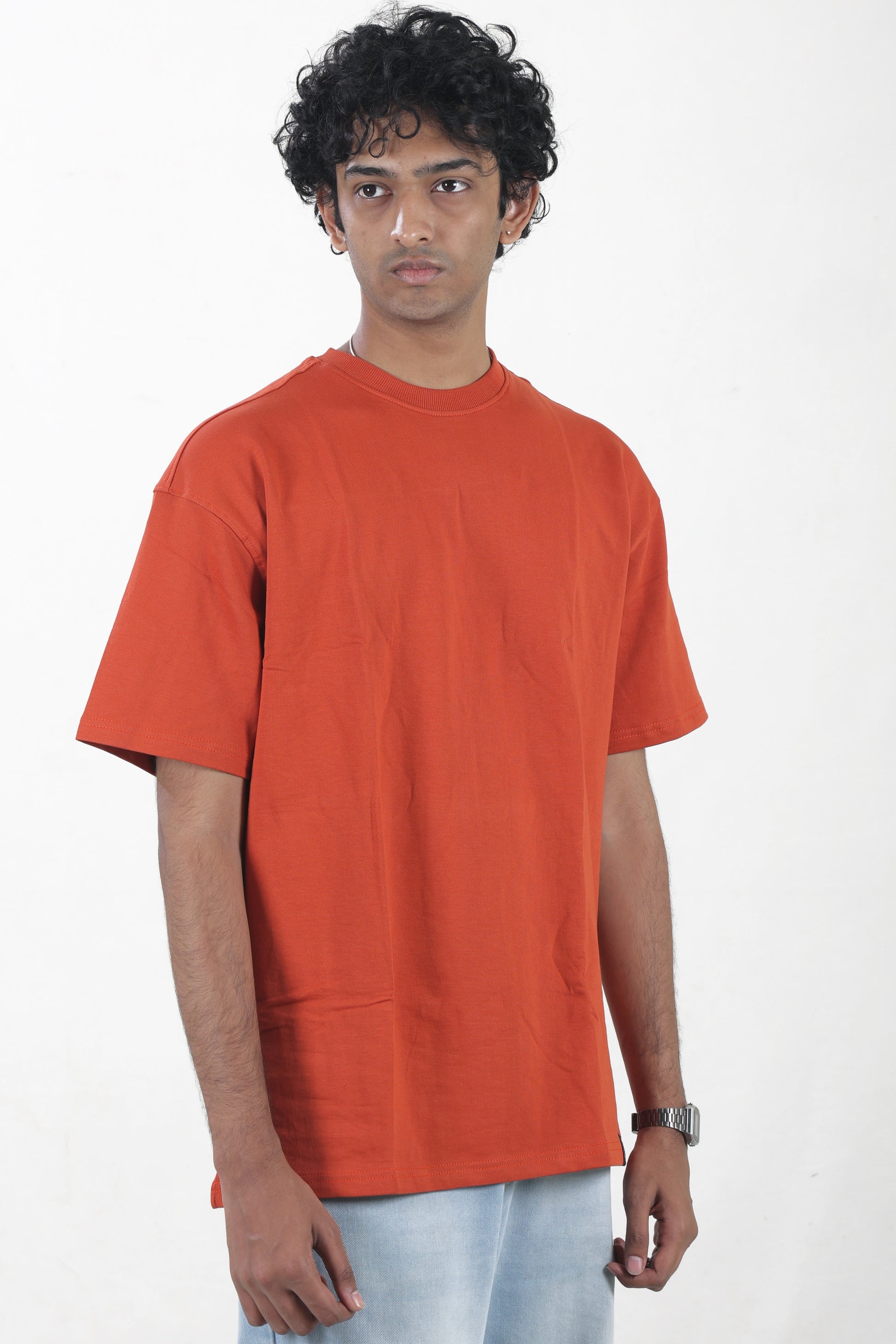 Person wearing an orange t-shirt on a white background