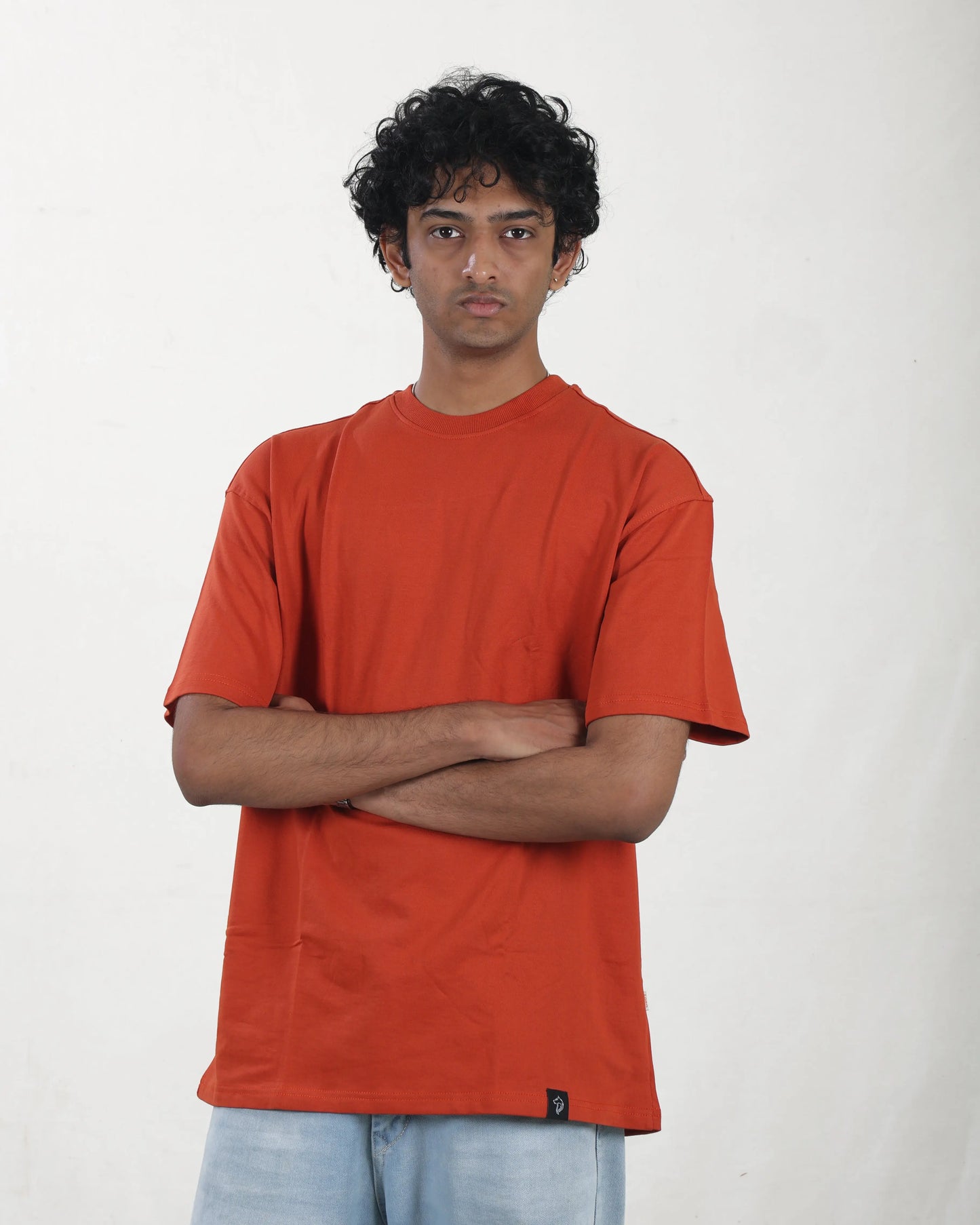 Person wearing an orange t-shirt against a white background