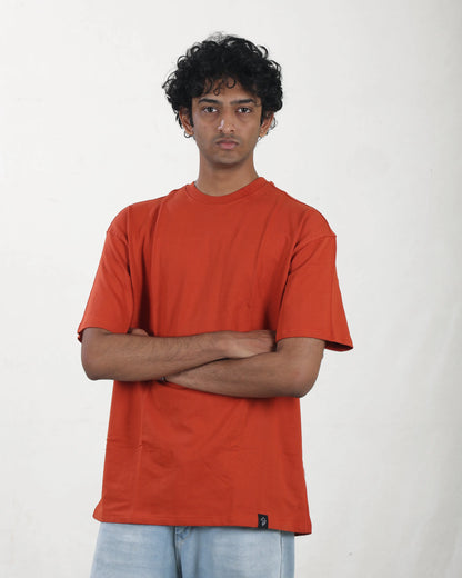 Person wearing an orange t-shirt against a white background