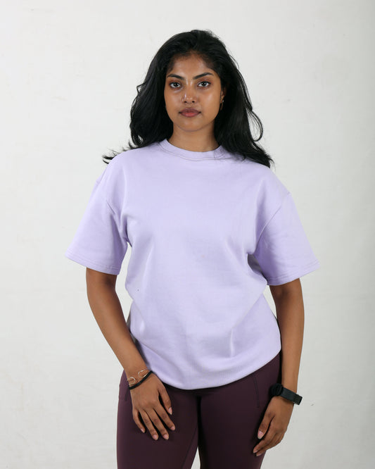 Person wearing a light purple t-shirt and maroon pants on a white background