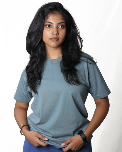 Woman wearing a plain blue t-shirt against a white background