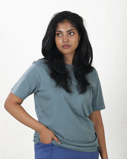 Woman wearing a light blue t-shirt against a white background