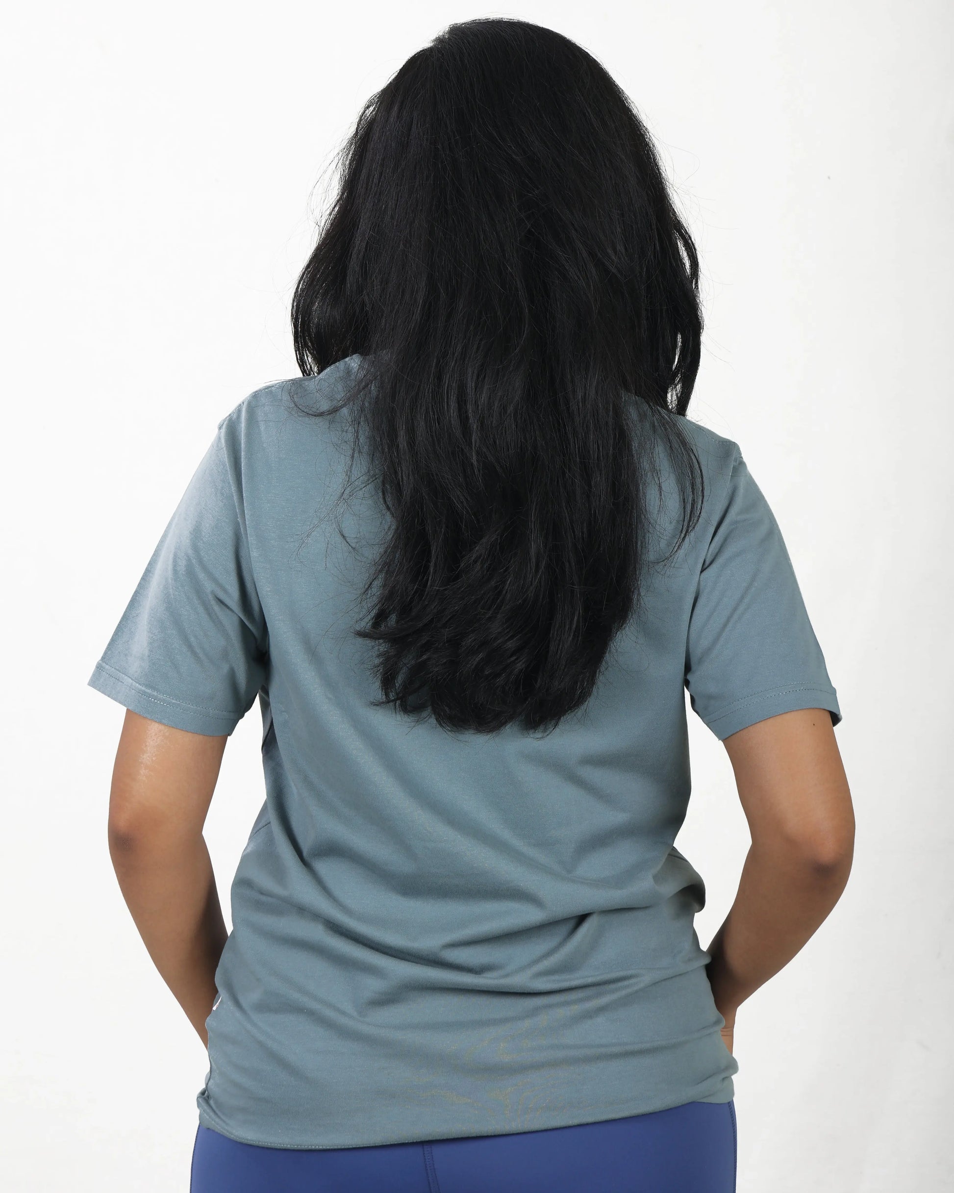 Person wearing a light blue t-shirt on a white background