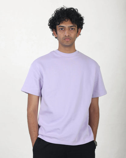 Person wearing a light purple t-shirt against a white background