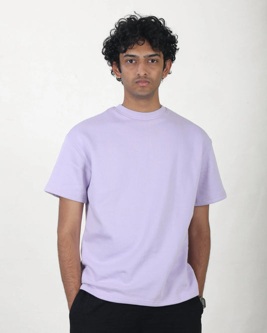 Person wearing a light purple t-shirt against a white background