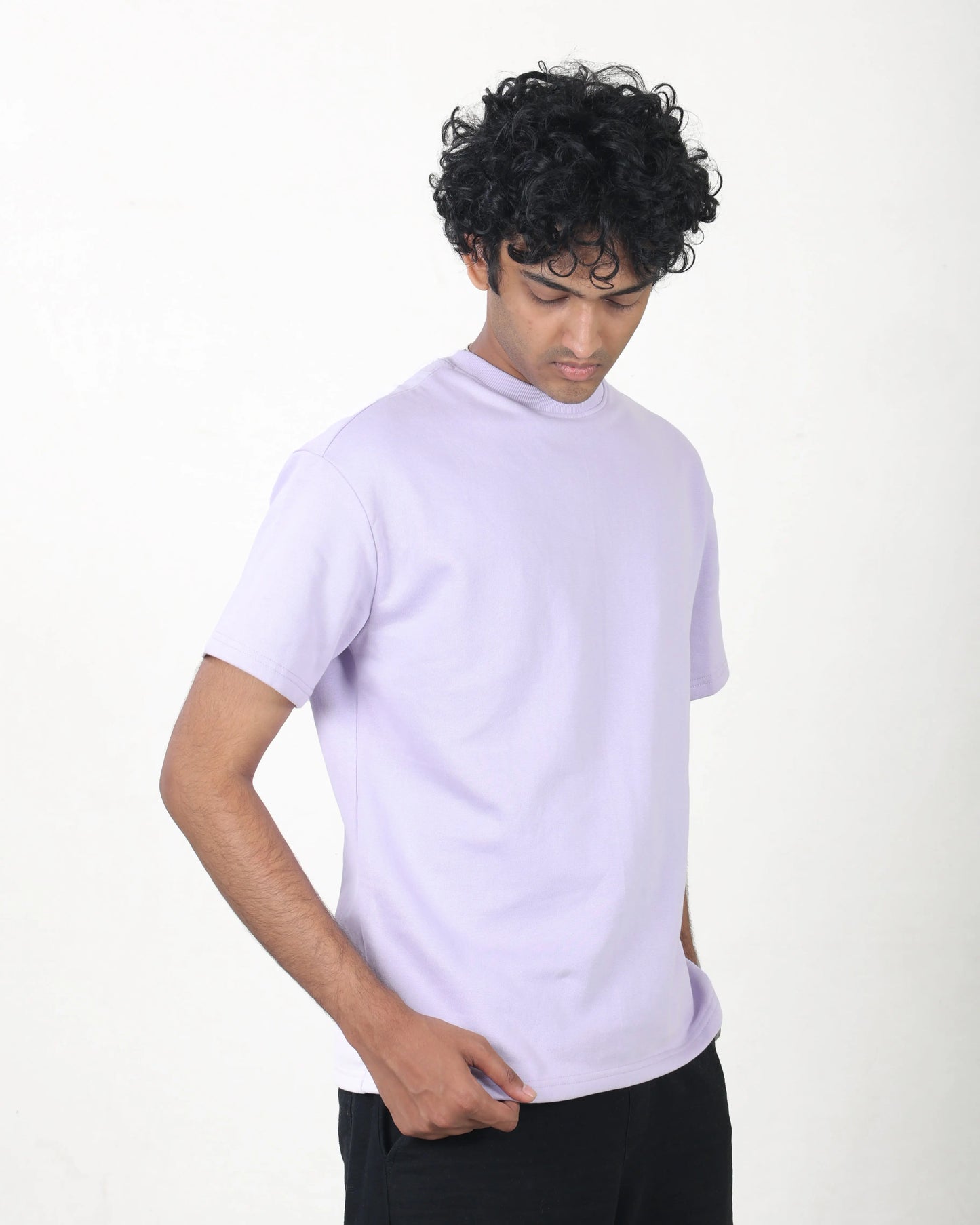 Person wearing a light purple t-shirt on a white background
