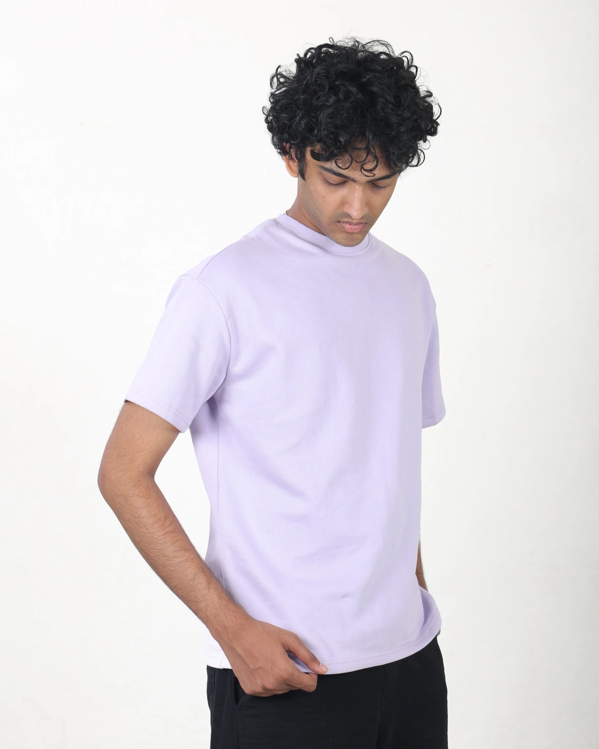 Person wearing a light purple t-shirt on a white background