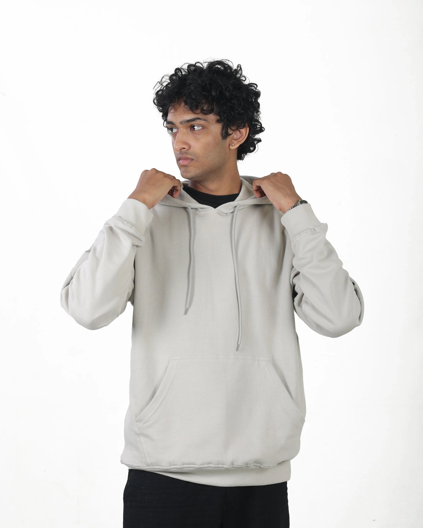 Man wearing a light gray hoodie on a white background