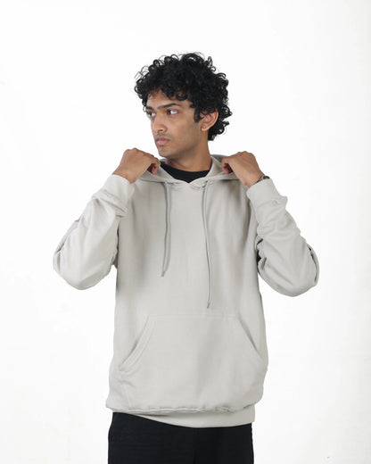 Man wearing a light gray hoodie on a white background