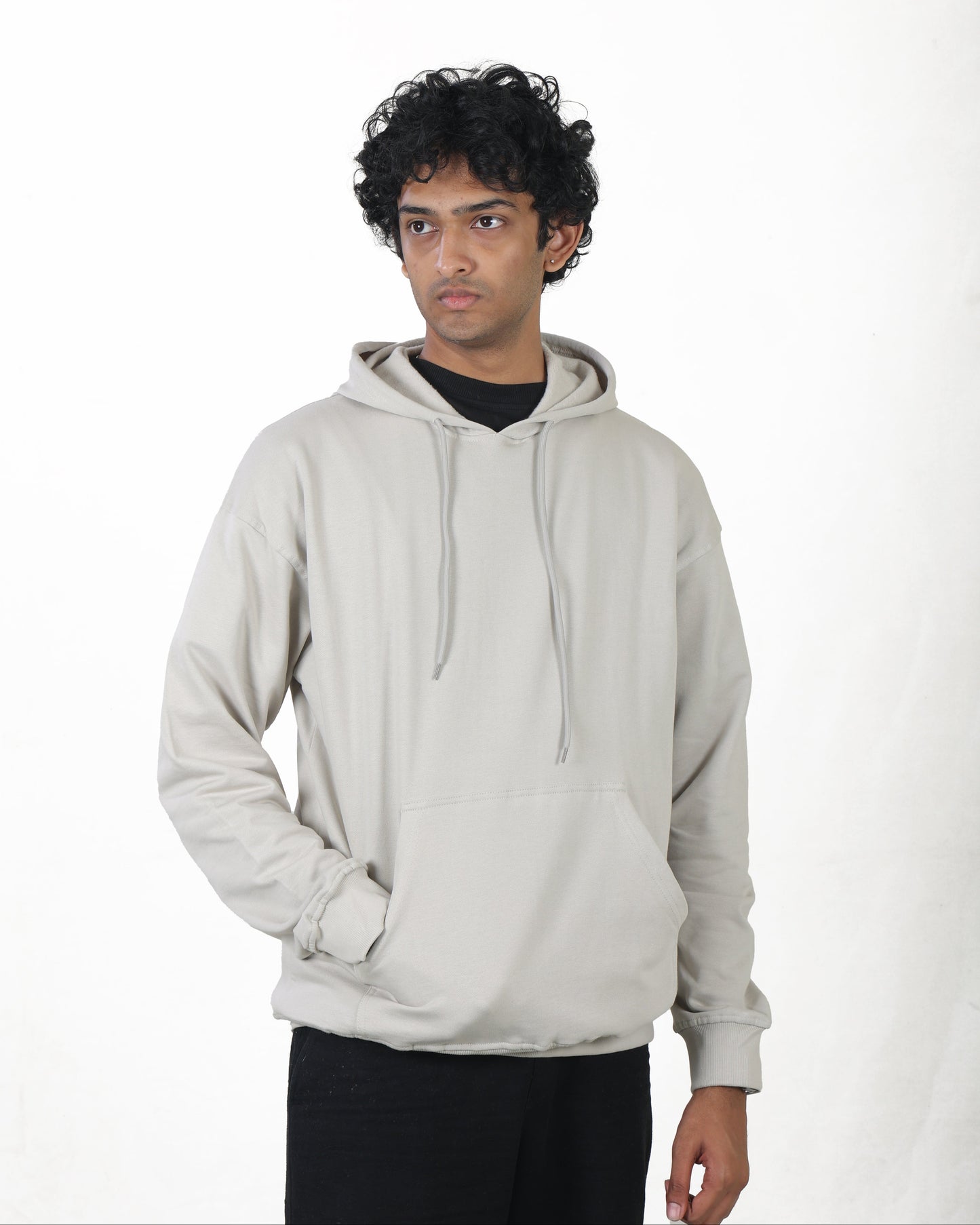 Person wearing a light gray hoodie on a white background