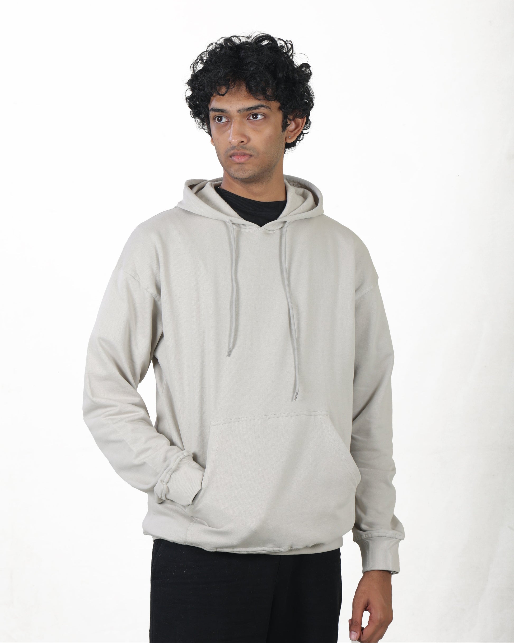 Person wearing a light gray hoodie on a white background
