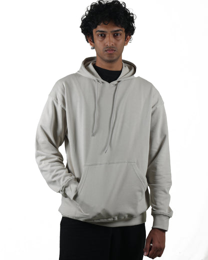Person wearing a light gray hoodie on a white background