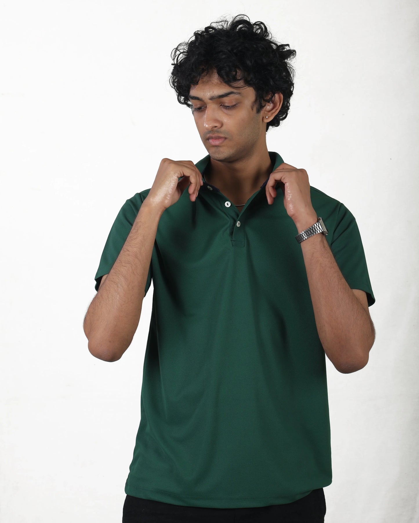 Man wearing a green polo shirt against a white background