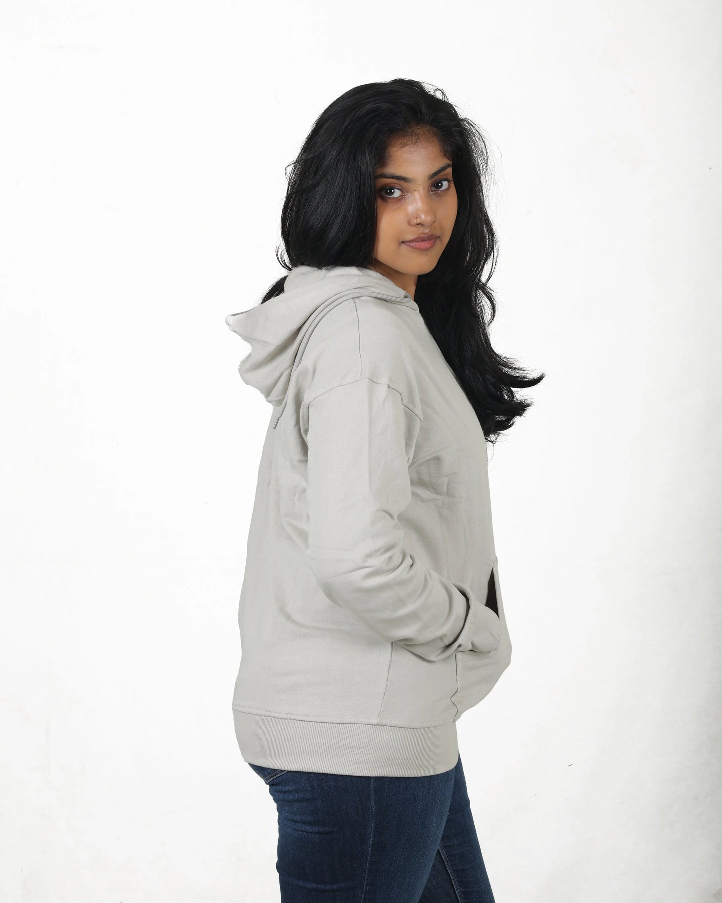 Woman wearing a light gray hoodie on a white background