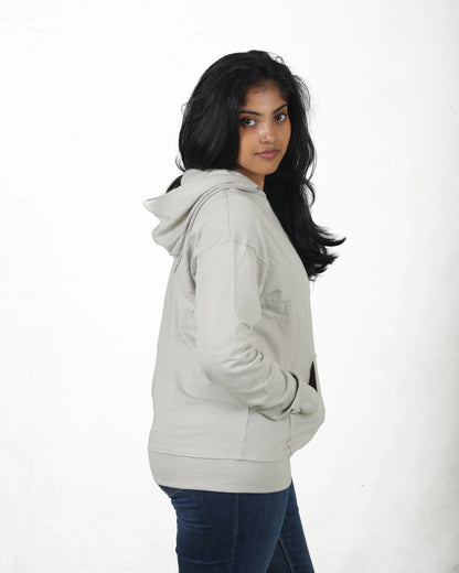 Woman wearing a light gray hoodie on a white background