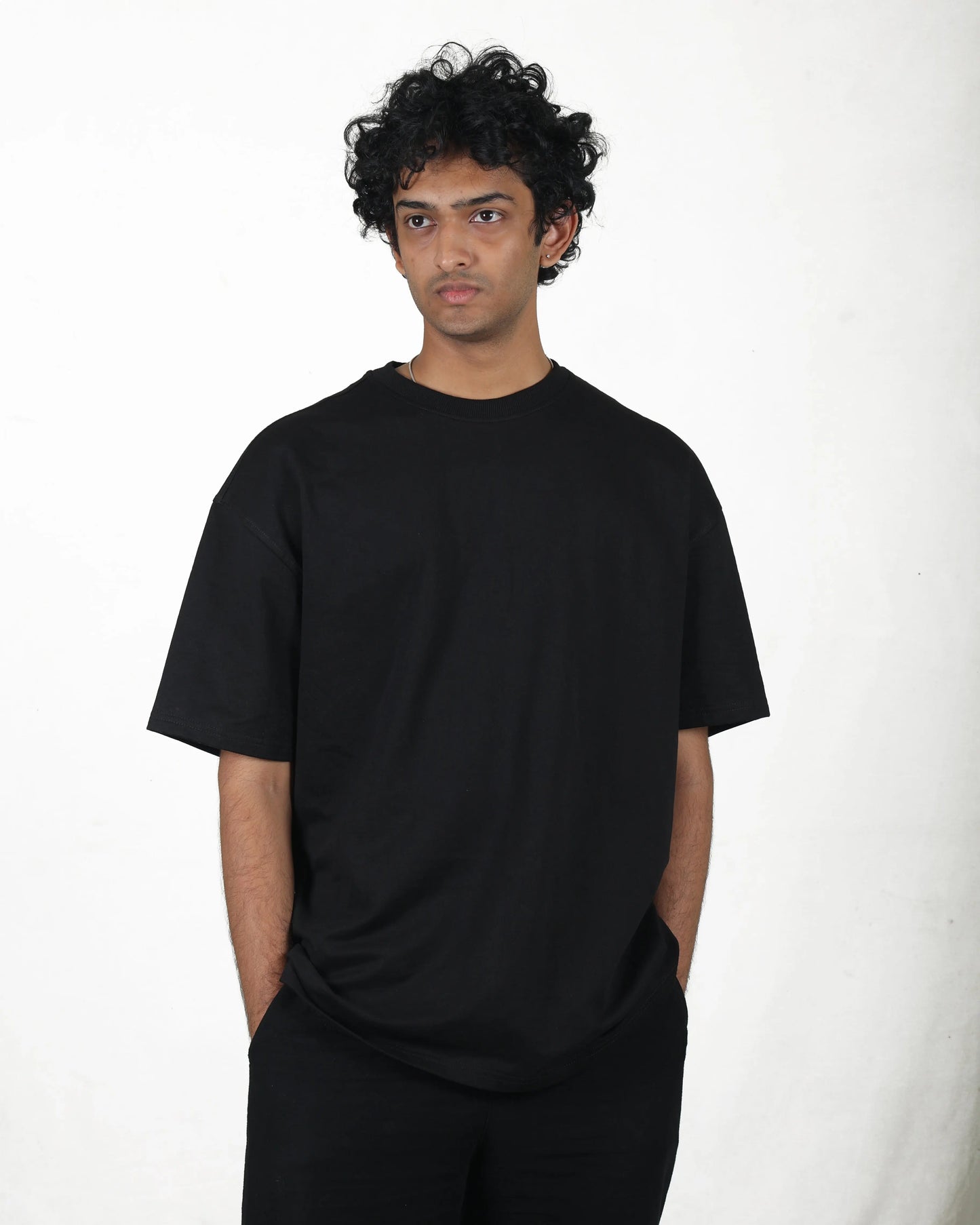 Person wearing a black t-shirt against a white background