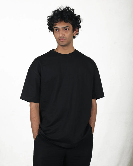 Person wearing a black t-shirt against a white background