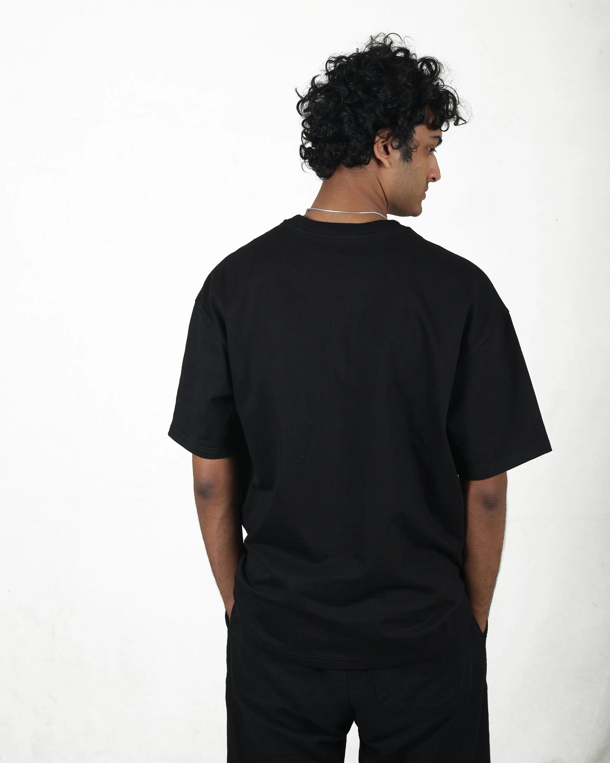 Person wearing a black t-shirt on a white background