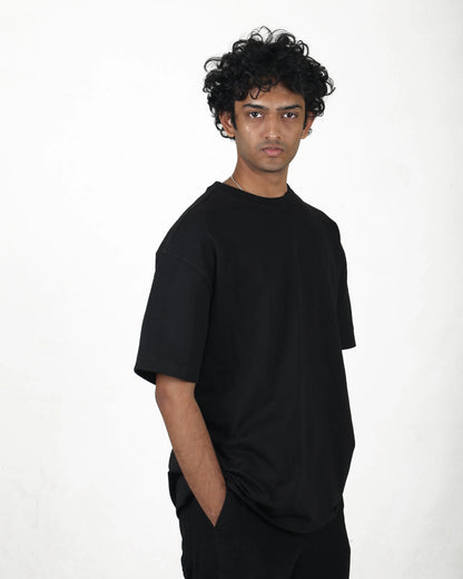 Person wearing a black t-shirt against a white background