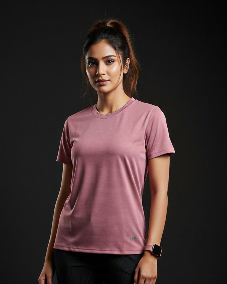 Woman wearing a pink t-shirt against a black background