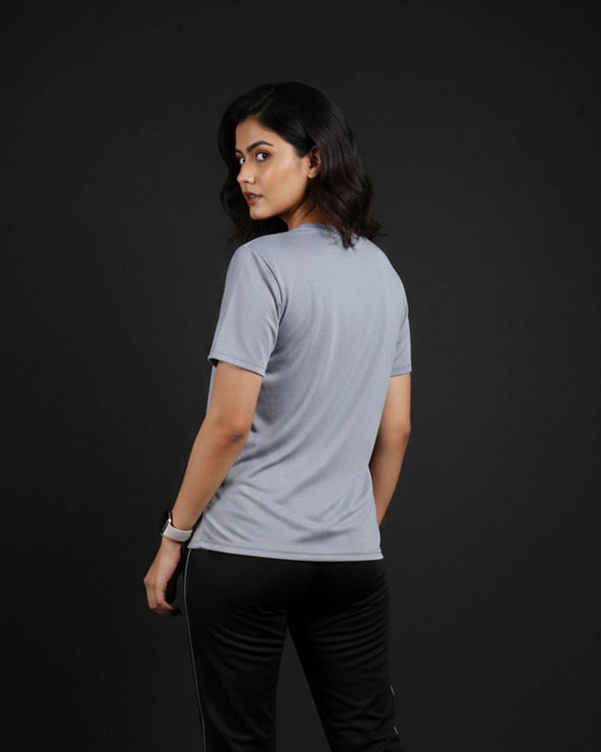 Woman wearing a light gray t-shirt on a black background