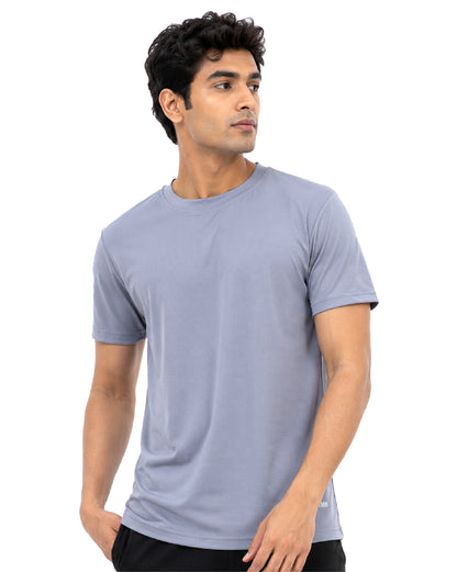 A man wearing a light blue-gray crew-neck t-shirt, shown from the waist up against a plain white background.