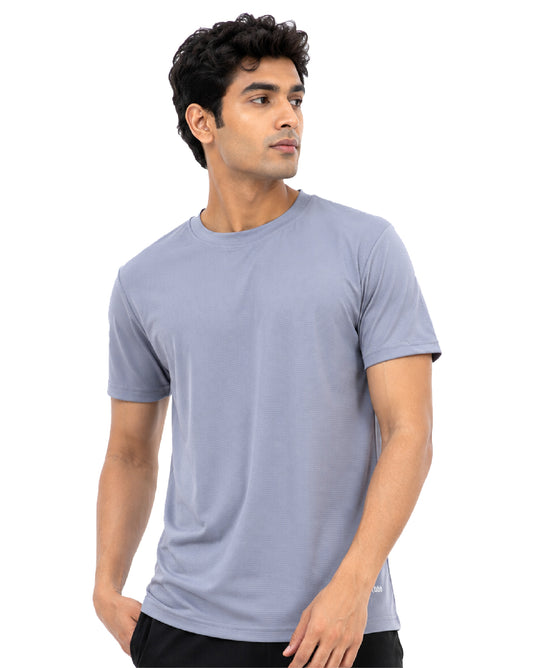 A man wearing a light blue-gray crew-neck t-shirt, shown from the waist up against a plain white background.