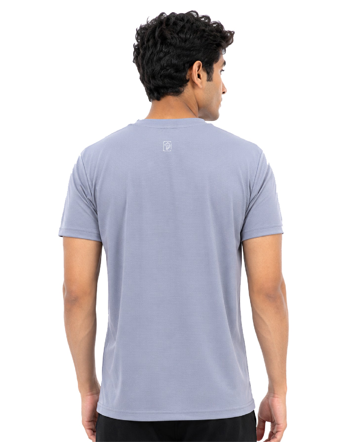 A man viewed from the back wearing a light periwinkle blue short-sleeve t-shirt with a small white logo on the upper back, set against a plain white background.