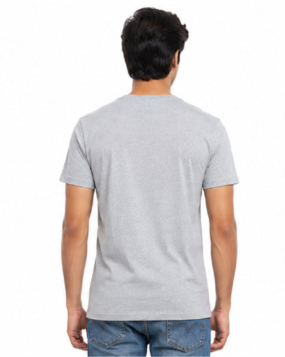 A man viewed from the back wearing a light gray short-sleeve crewneck t-shirt and blue jeans, set against a plain white background.