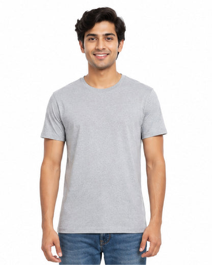A man wearing a light gray short-sleeve crewneck t-shirt and blue jeans, standing against a plain white background.