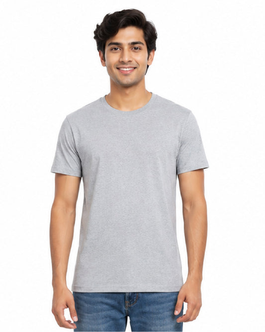 A man wearing a light gray short-sleeve crewneck t-shirt and blue jeans, standing against a plain white background.