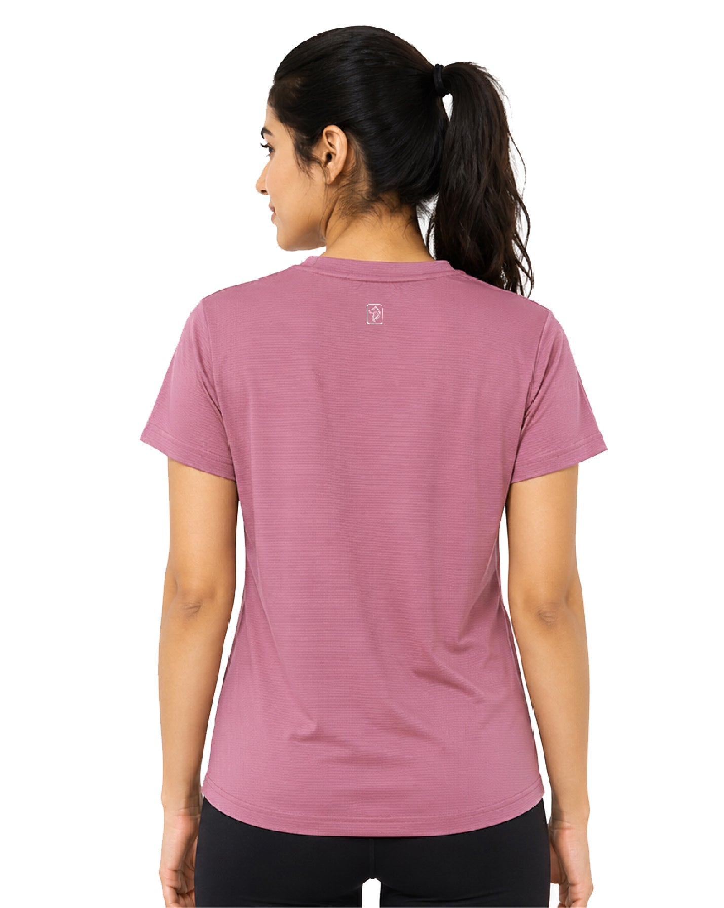 A woman viewed from the back wearing a dusty rose short-sleeve athletic t-shirt and black leggings against a plain white background.