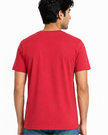 A man viewed from the back wearing a solid red short-sleeve crewneck t-shirt and blue jeans, set against a plain white studio background.