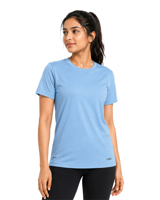 A woman wearing a light blue short-sleeve athletic t-shirt and black leggings, standing against a plain white background.